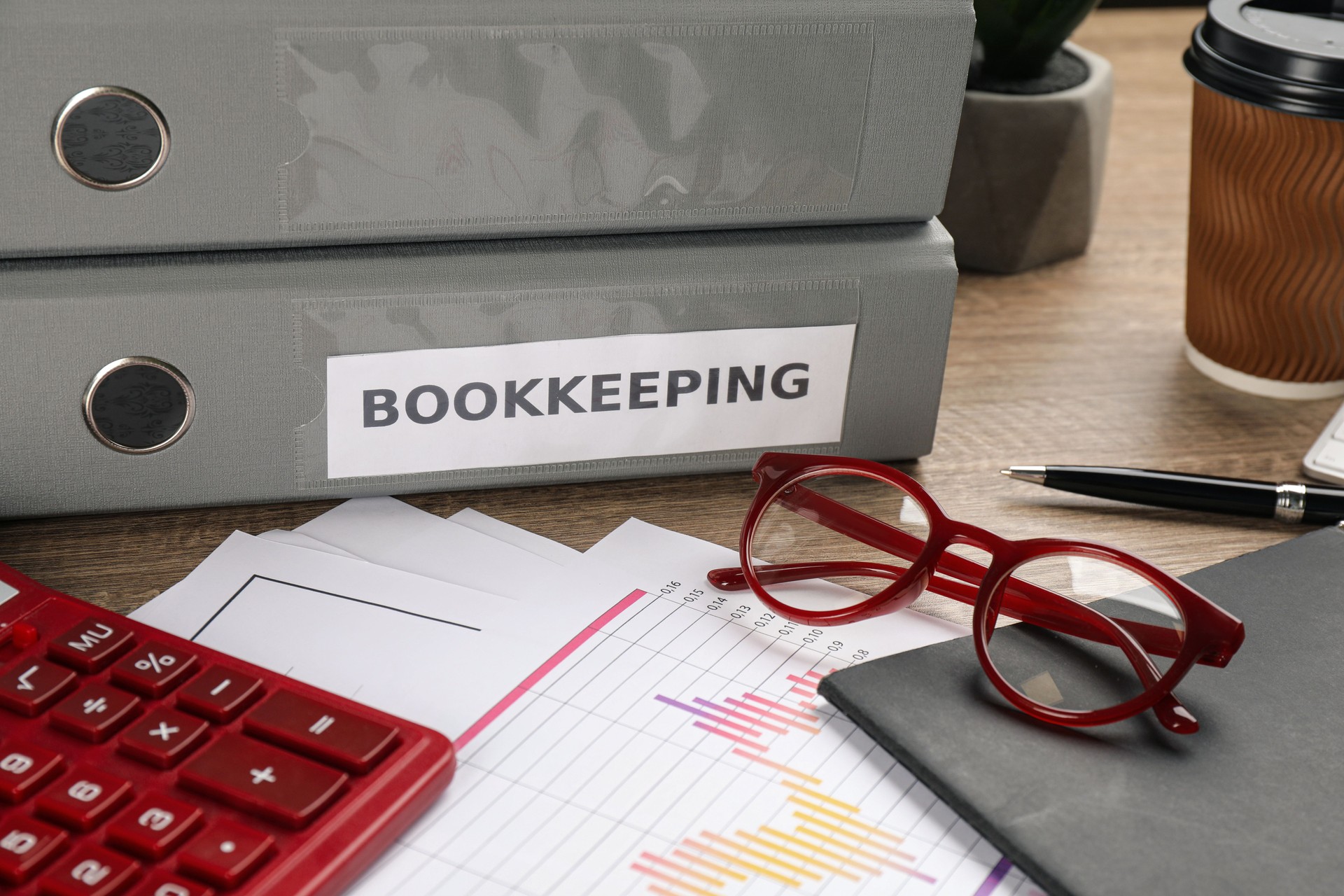 Bookkeeper's workplace with folders and documents on table